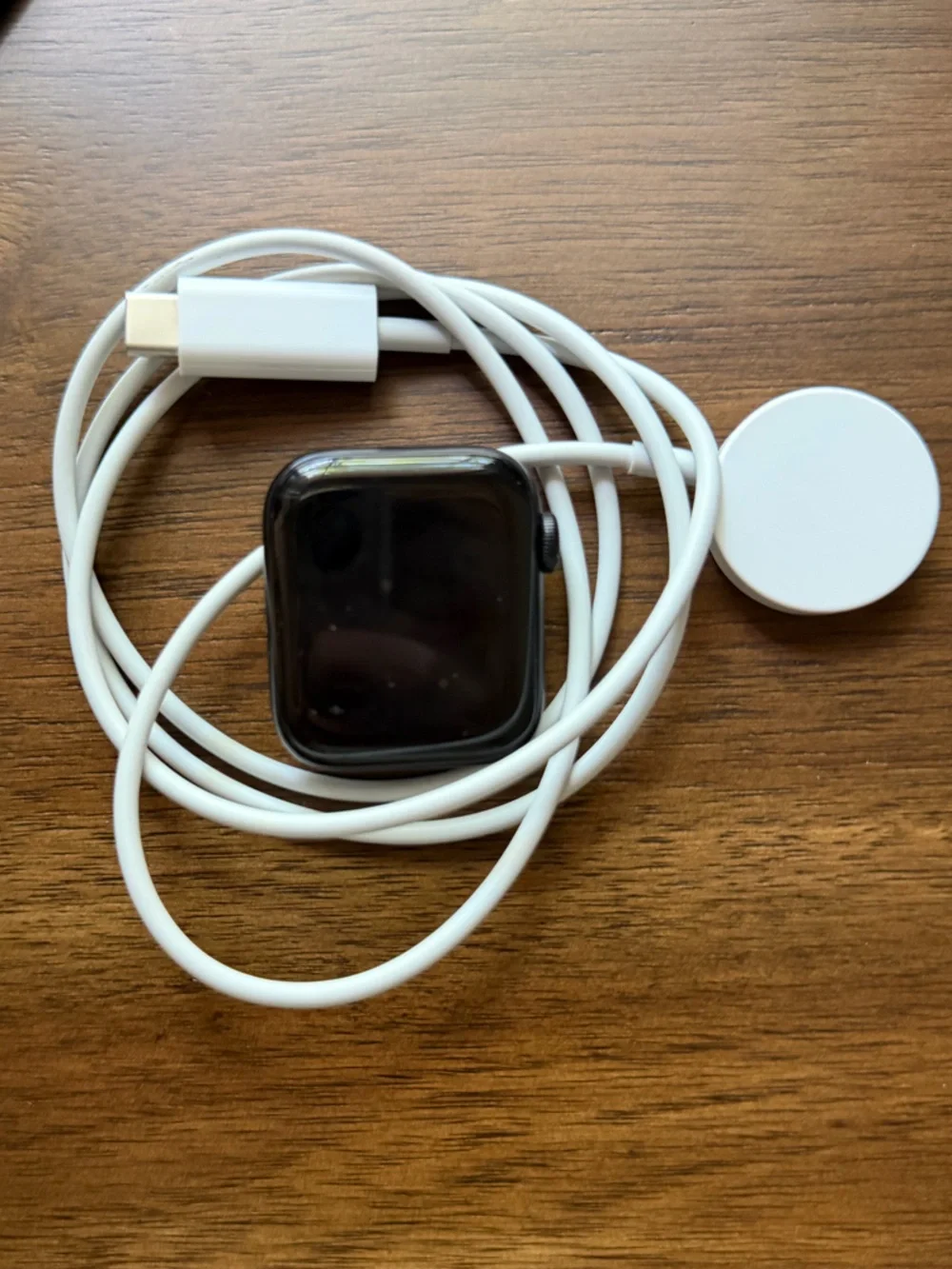 Apple Smartwatch with White Magnetic Charger - Black Watch Face